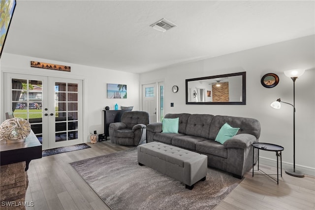 living room featuring french doors and hardwood / wood-style flooring