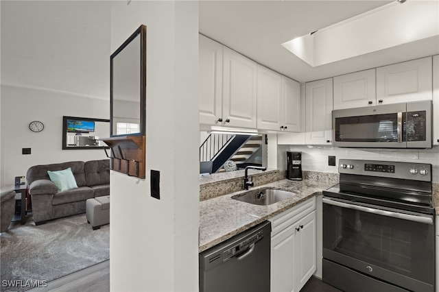 kitchen with white cabinetry, sink, and appliances with stainless steel finishes