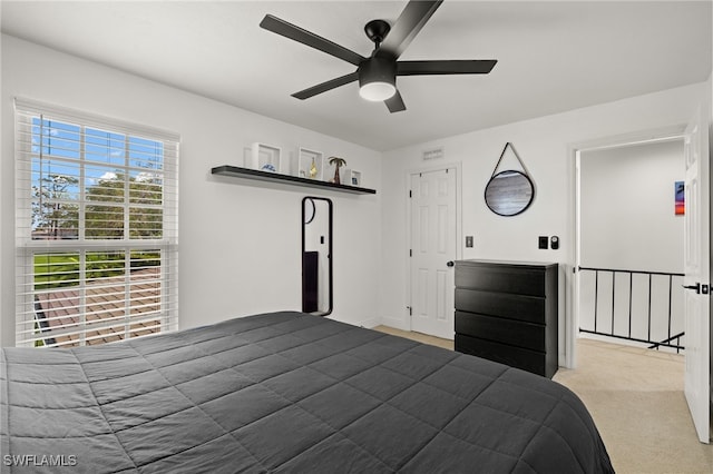 bedroom with ceiling fan and light colored carpet