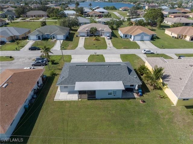 bird's eye view with a residential view and a water view