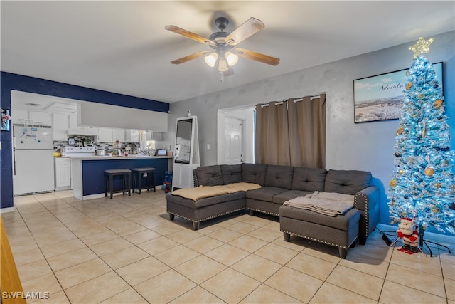 living room with ceiling fan and light tile patterned floors