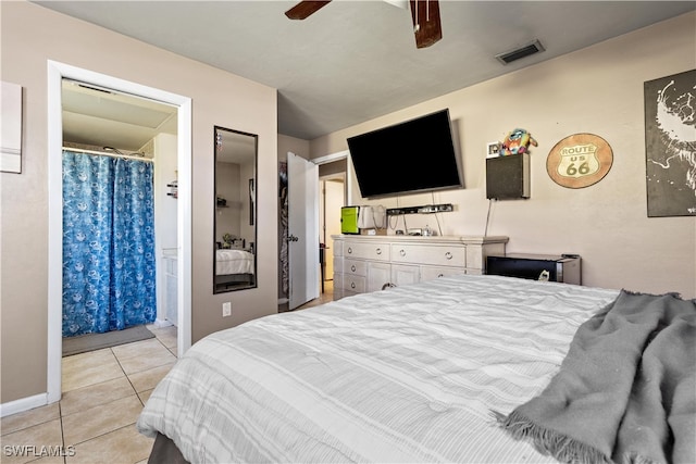 tiled bedroom featuring ensuite bath and ceiling fan