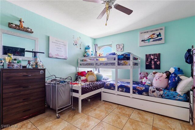 tiled bedroom featuring ceiling fan