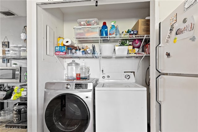 washroom with washer and clothes dryer