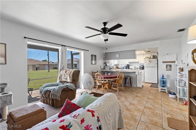 living room featuring ceiling fan and light tile patterned floors