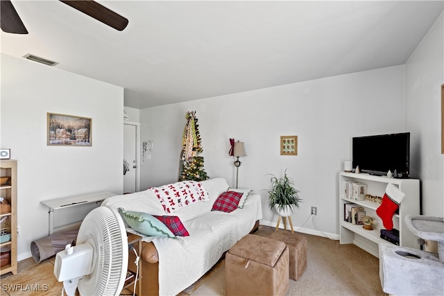 living room featuring ceiling fan and light colored carpet