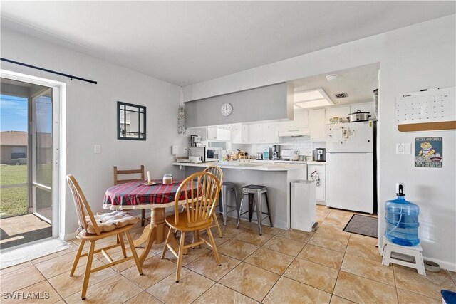 dining space featuring light tile patterned floors