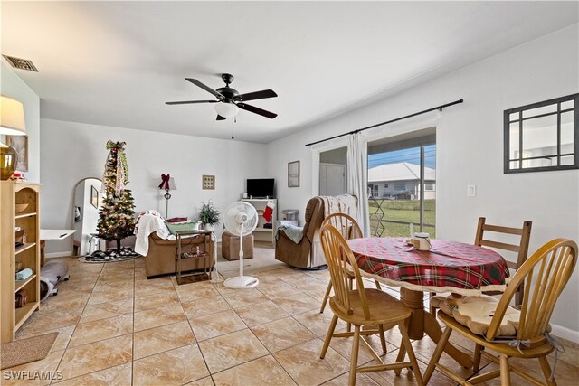 dining space with ceiling fan and light tile patterned flooring