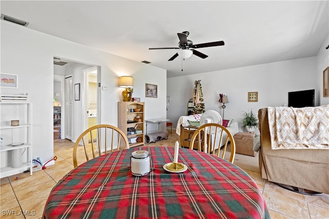 tiled dining space with ceiling fan