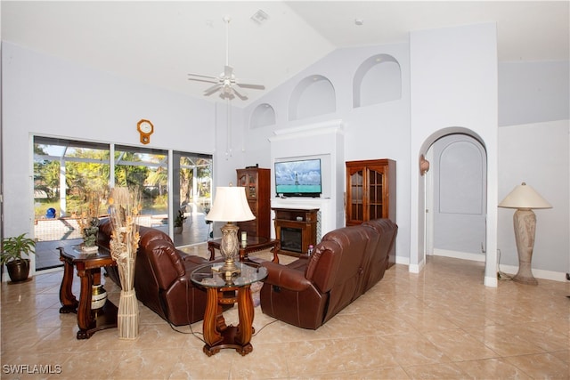 tiled living room featuring high vaulted ceiling and ceiling fan