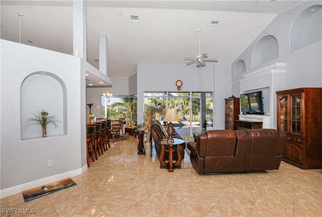 living room featuring ceiling fan and high vaulted ceiling