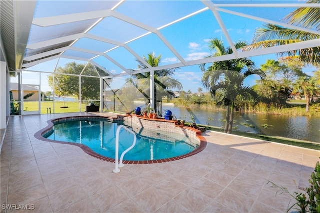 view of pool featuring glass enclosure, a patio area, and a water view