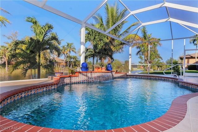 view of pool featuring pool water feature, a patio, and glass enclosure