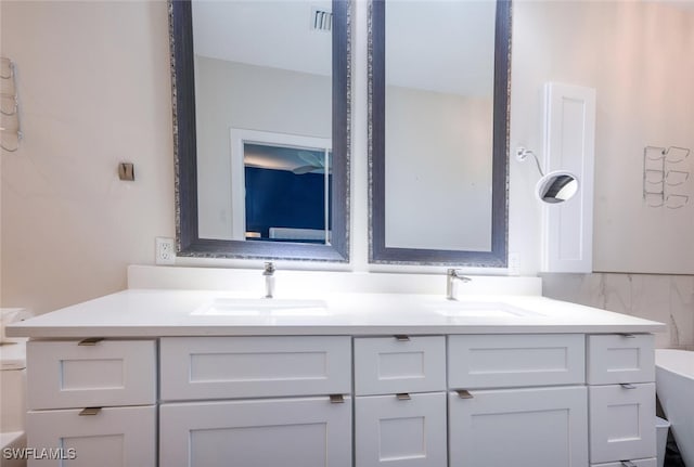 bathroom with vanity and a tub to relax in