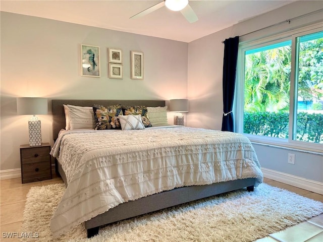 bedroom with light tile patterned flooring, multiple windows, and ceiling fan