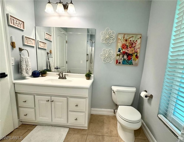 bathroom featuring toilet, tile patterned flooring, and vanity