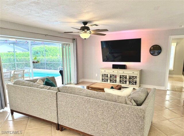 tiled living room featuring a textured ceiling and ceiling fan