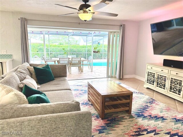 living room with tile patterned floors, a textured ceiling, and ceiling fan