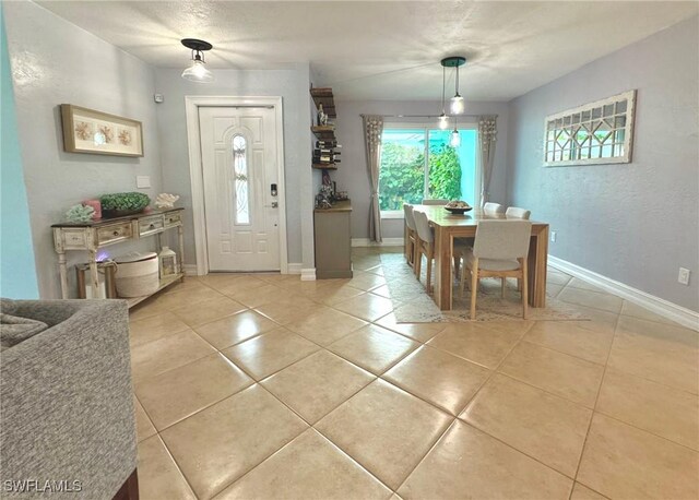 foyer entrance with light tile patterned floors