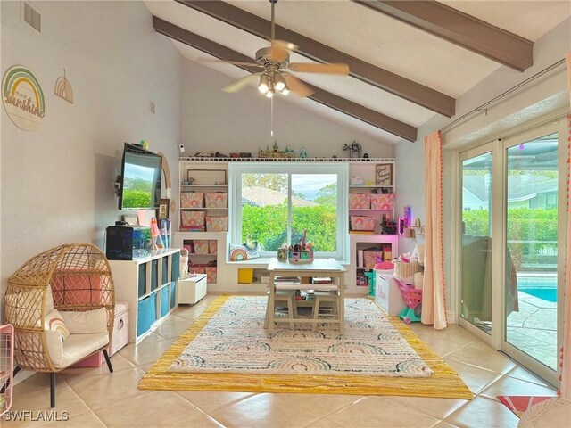 recreation room with light tile patterned floors, ceiling fan, and lofted ceiling with beams