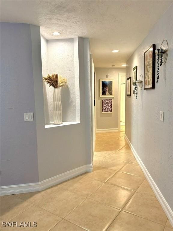 hallway featuring light tile patterned flooring