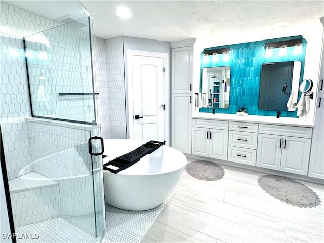 bathroom featuring tasteful backsplash, vanity, and plus walk in shower