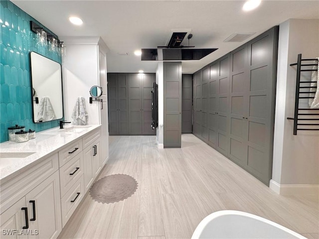 bathroom featuring vanity, hardwood / wood-style floors, and a bathtub