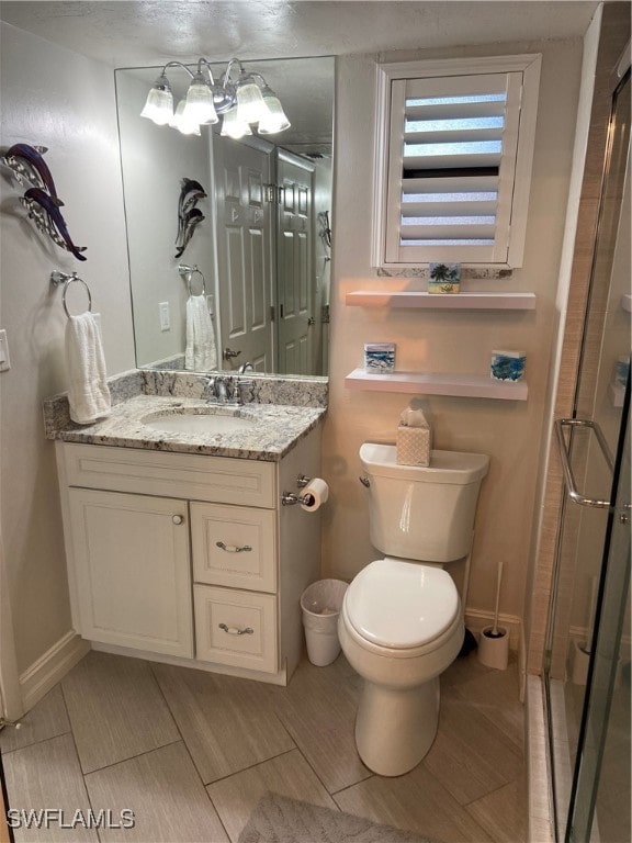 bathroom with vanity, toilet, and walk in shower