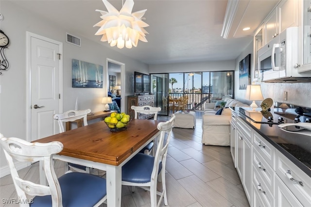 dining area featuring an inviting chandelier