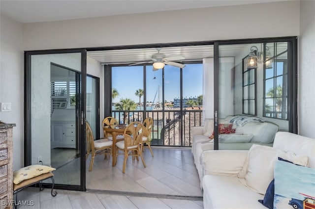 sunroom / solarium with a wealth of natural light and ceiling fan