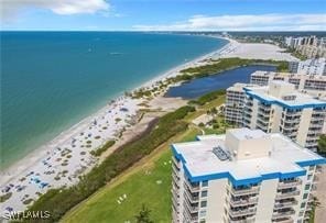 birds eye view of property with a water view and a view of the beach