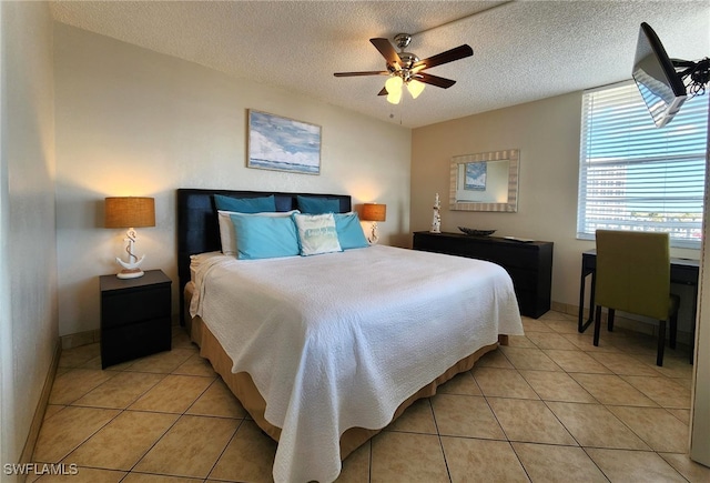 bedroom with light tile patterned floors, a textured ceiling, and ceiling fan