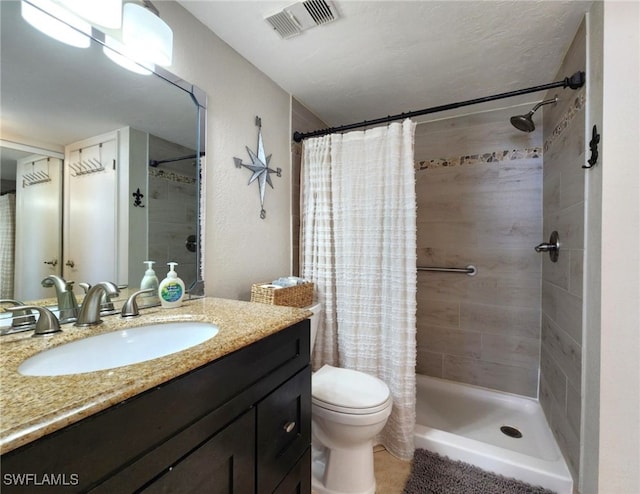 bathroom featuring vanity, curtained shower, and toilet