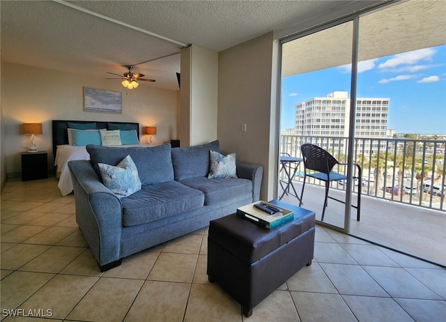 tiled living room featuring floor to ceiling windows, a textured ceiling, and ceiling fan