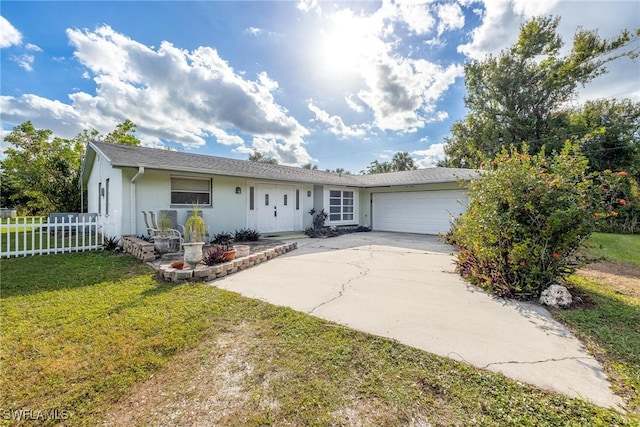 single story home with a garage and a front lawn