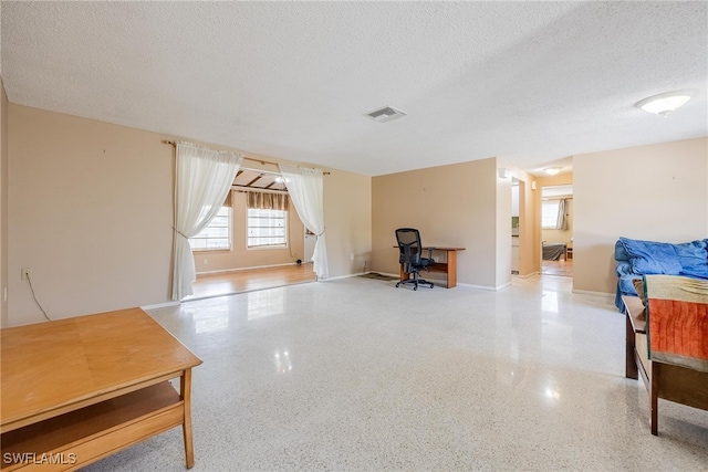 interior space with a textured ceiling