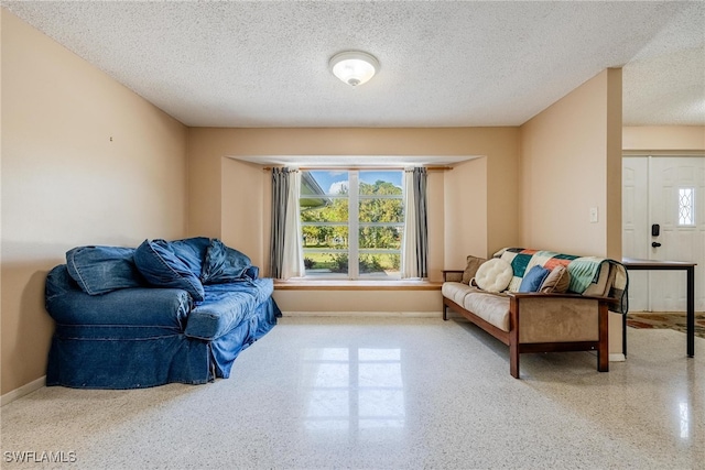 living area featuring a textured ceiling