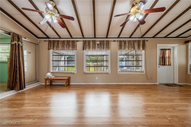 empty room with light hardwood / wood-style floors, ceiling fan, and lofted ceiling