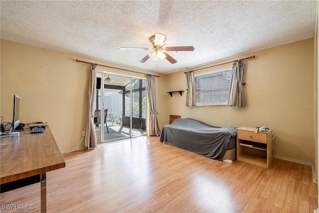 bedroom with ceiling fan, a textured ceiling, access to outside, and light hardwood / wood-style flooring