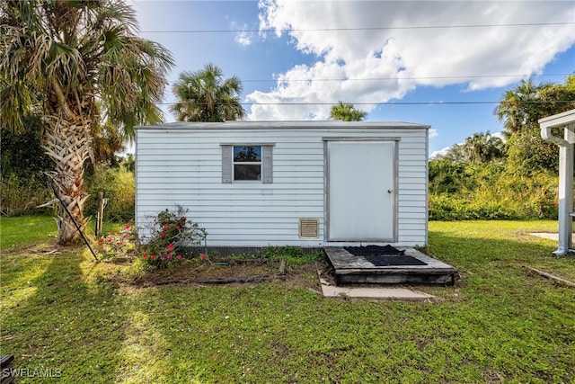 view of outbuilding with a lawn