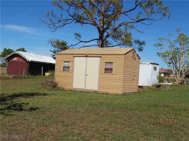 view of outbuilding with a lawn