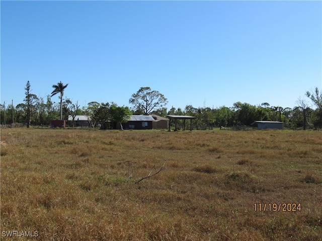 view of yard with a rural view