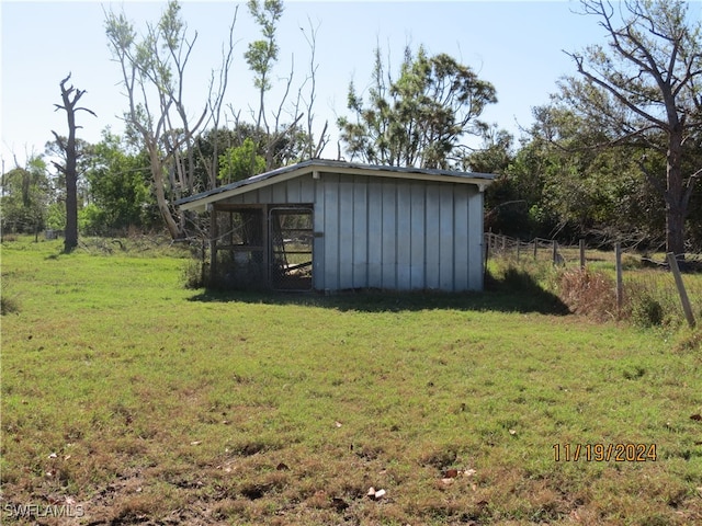 view of outbuilding with a lawn