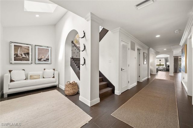 corridor featuring ornamental molding, lofted ceiling, and dark wood-type flooring