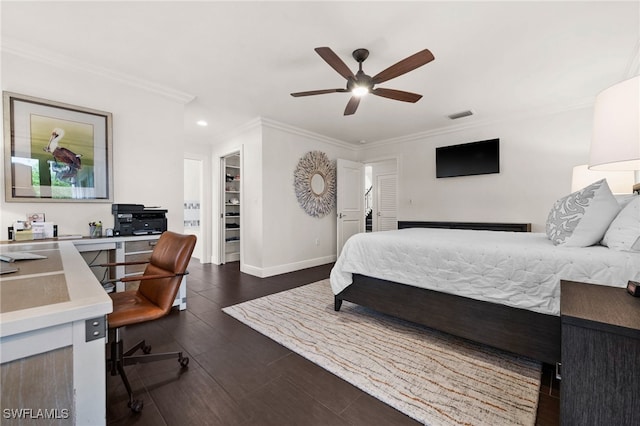 bedroom with a walk in closet, ceiling fan, a closet, and ornamental molding