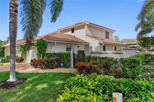 5908 Via Lugano, Naples, FL 34108 - mediterranean / spanish-style home with a tiled roof, stucco siding, and a garage