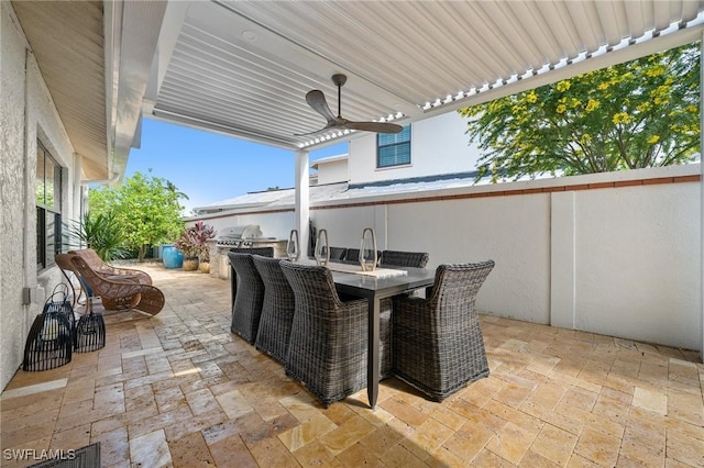 5908 Via Lugano, Naples, FL 34108 - view of patio / terrace with exterior kitchen, ceiling fan, and outdoor dining space