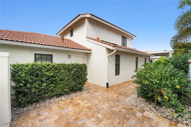 5908 Via Lugano, Naples, FL 34108 - rear view of house with stucco siding and a tile roof