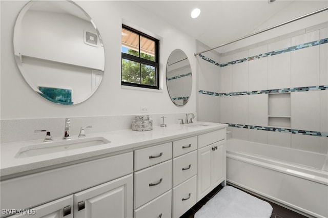 bathroom featuring vanity and  shower combination