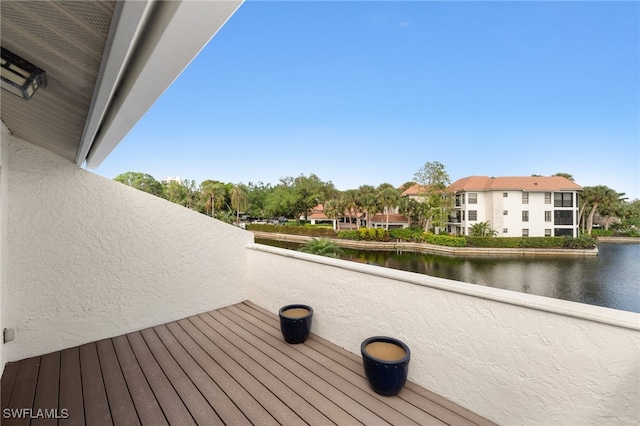 wooden terrace featuring a water view